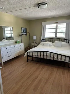 a large bed sitting in a room next to a window
