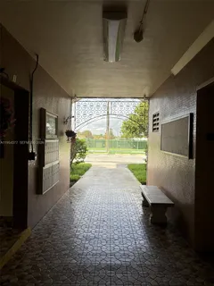 a view of a porch with wooden floor and a yard