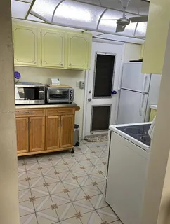 a kitchen with stainless steel appliances a refrigerator and a sink
