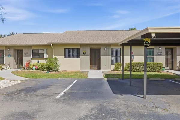 a view of a house with porch and garden