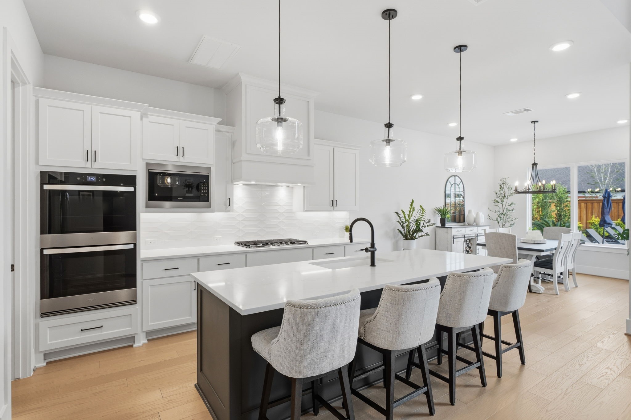 4708 Lorelai Lane Spring, TX 77386 - Photo 12 of 50 a kitchen with stainless steel appliances kitchen island granite countertop a table chairs microwave and sink
