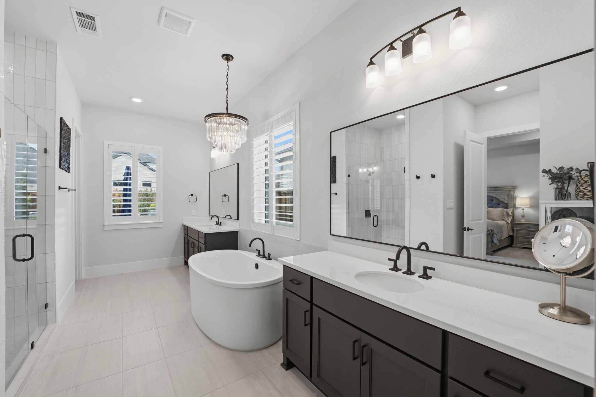 4708 Lorelai Lane Spring, TX 77386 - Photo 21 of 50 a bathroom with a double vanity sink a large mirror and a shower