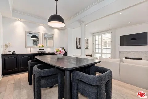 a kitchen with a table chairs sink and cabinets