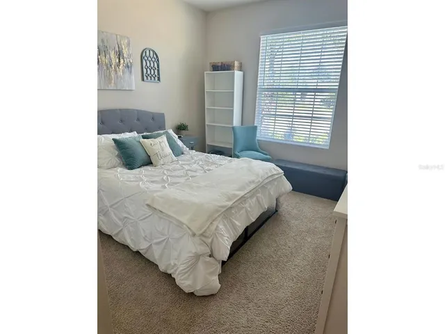 a bedroom with a bed and a window