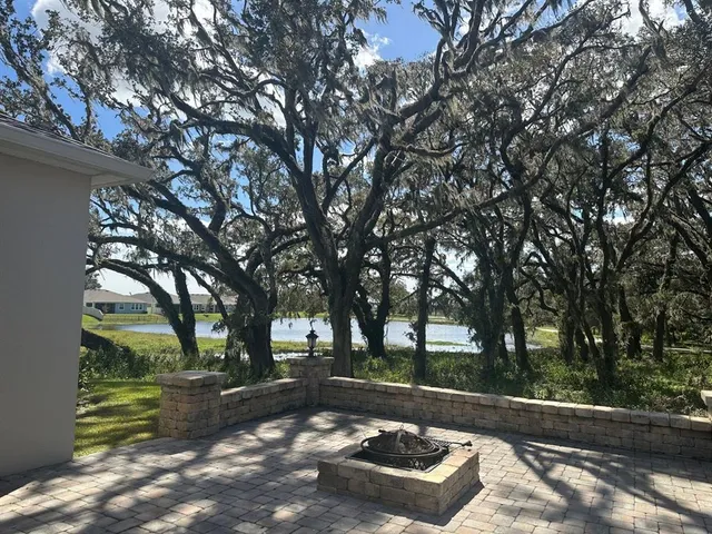 a view of a yard with wooden fence