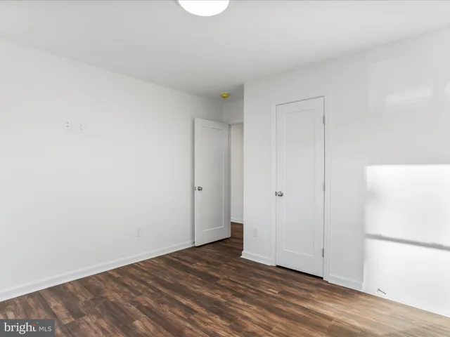 a view of an empty room and wooden floor