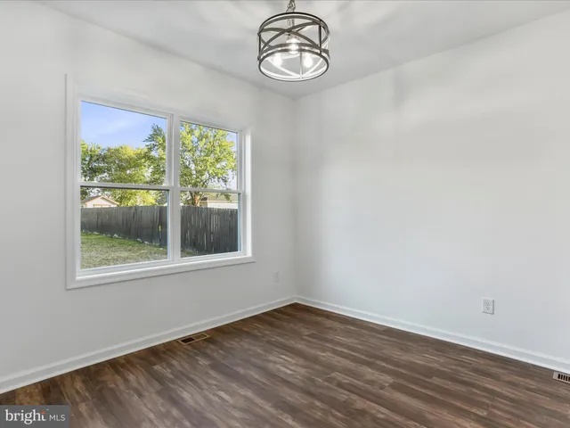 a view of a room with wooden floor and window