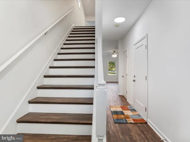 a view of entryway and hall with wooden floor