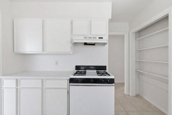 1655 Hawthorne Street Houston, TX 77006 - Photo 37 of 39 a kitchen with granite countertop white cabinets and a stove
