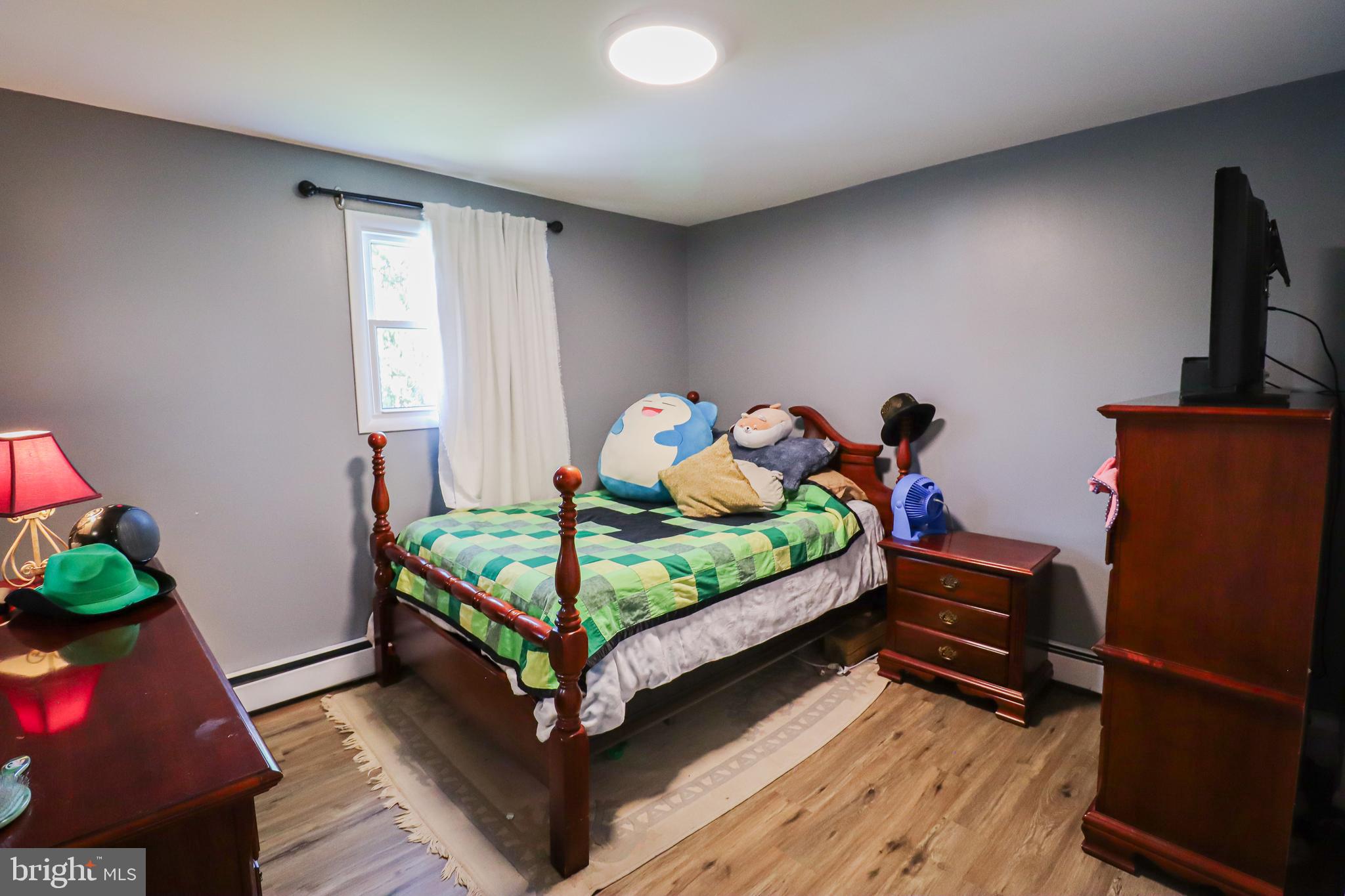 156 South Ritters Lane Owings Mills, MD 21117 - Photo 23 of 42 a bedroom with a bed and wooden floor