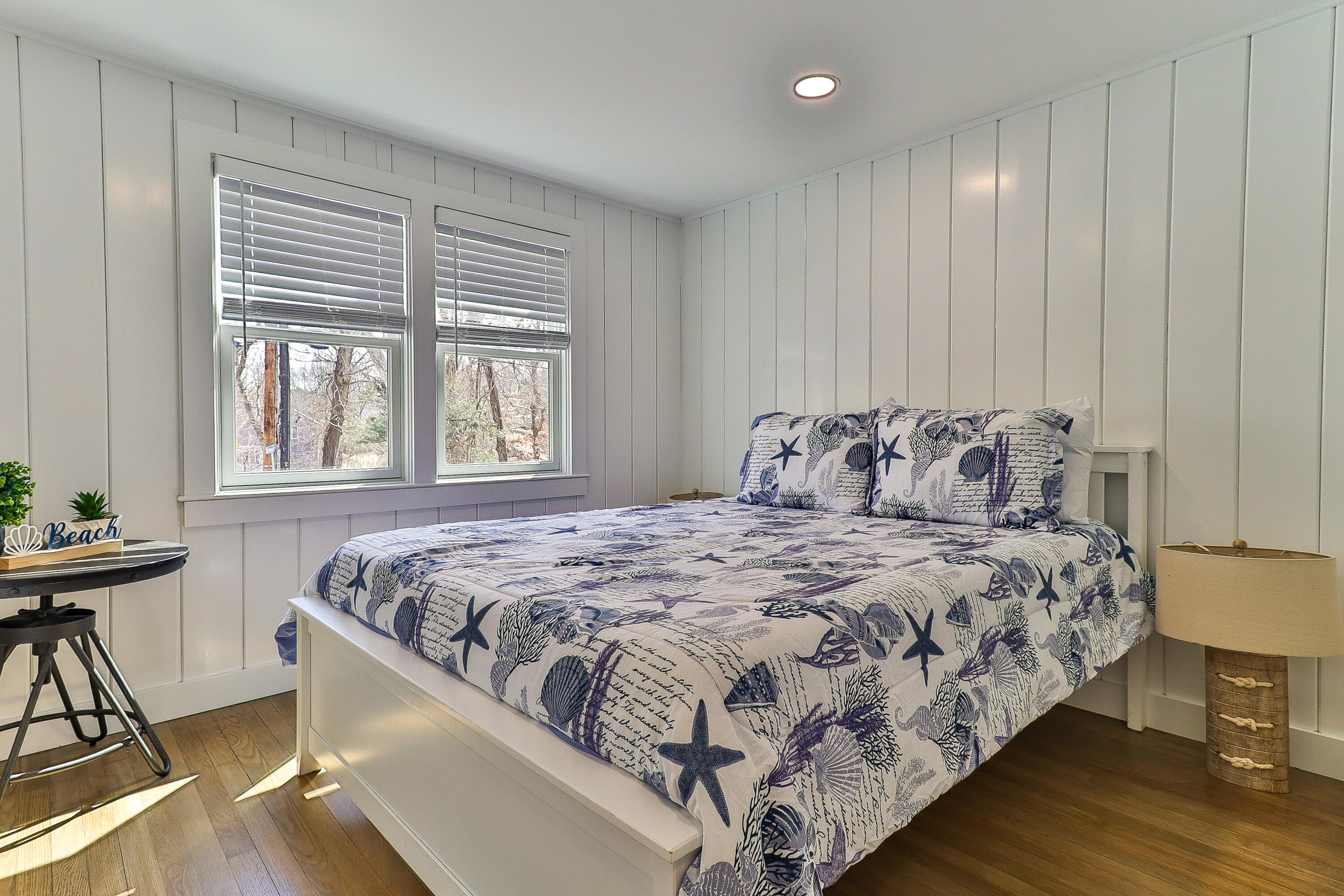 49 Huckins Neck Road Centerville, MA 02632 - Photo 13 of 23 a bedroom with a bed and a table