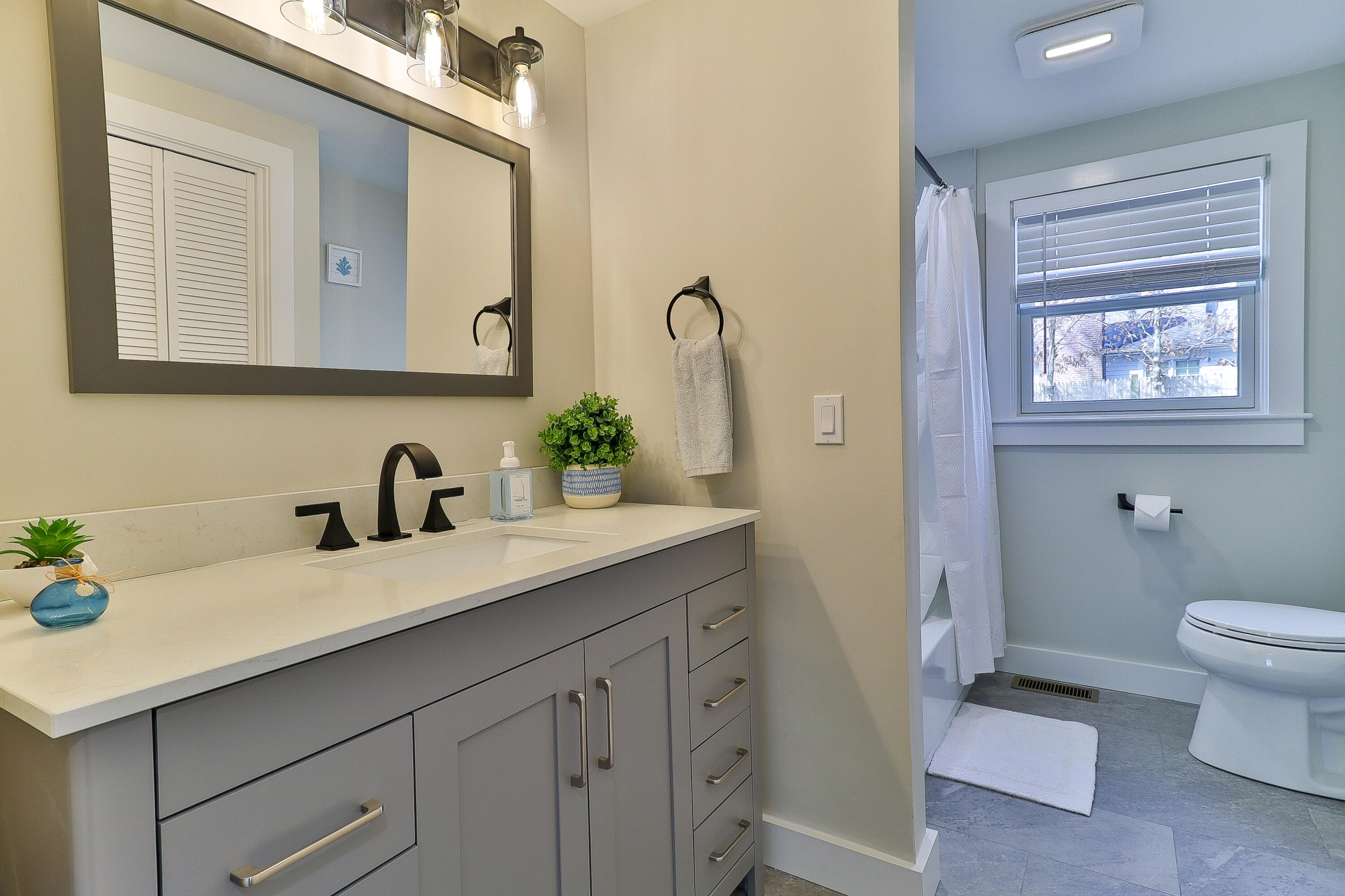 49 Huckins Neck Road Centerville, MA 02632 - Photo 15 of 23 a bathroom with a granite countertop sink and a mirror