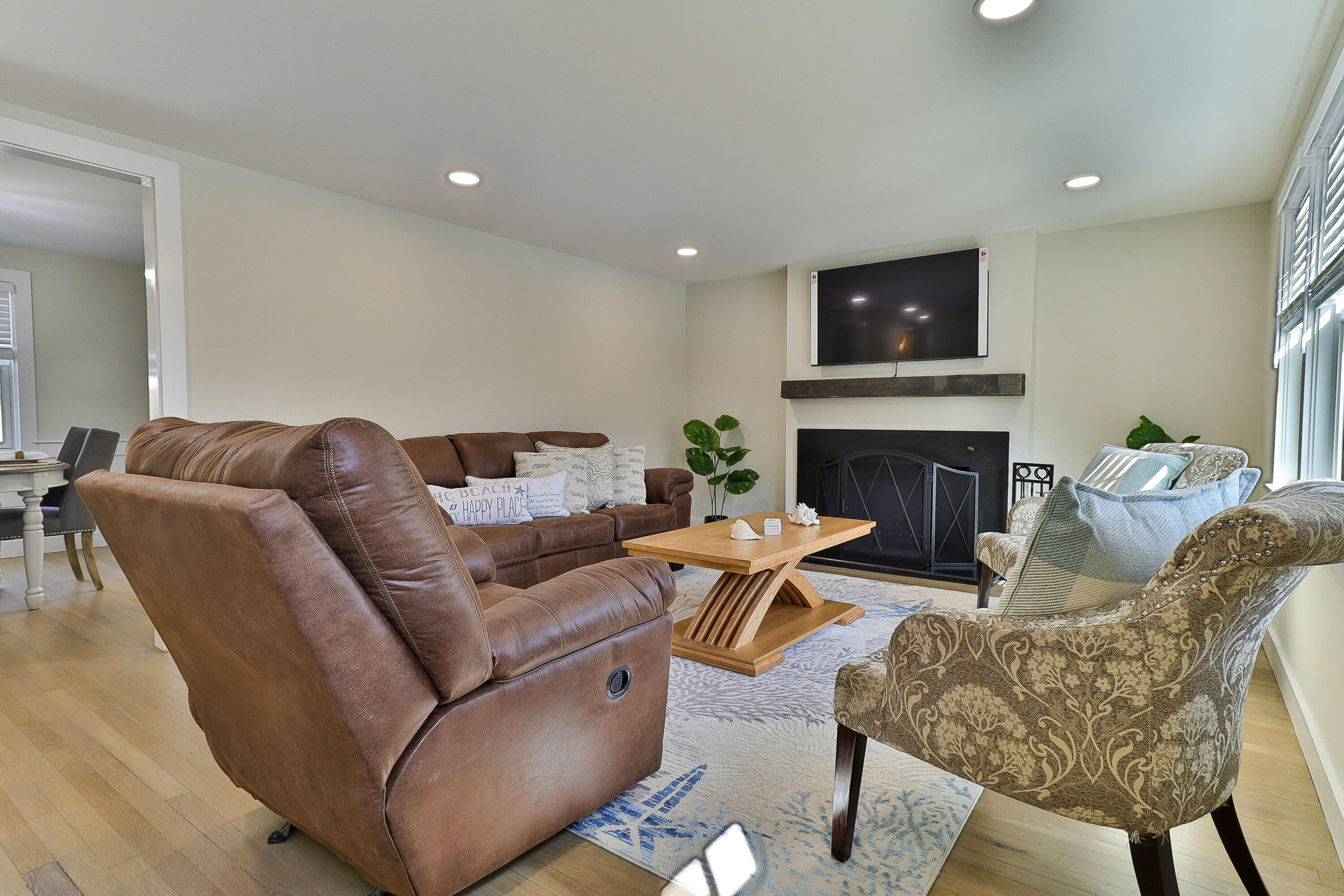49 Huckins Neck Road Centerville, MA 02632 - Photo 2 of 23 a living room with furniture a flat screen tv and a fireplace