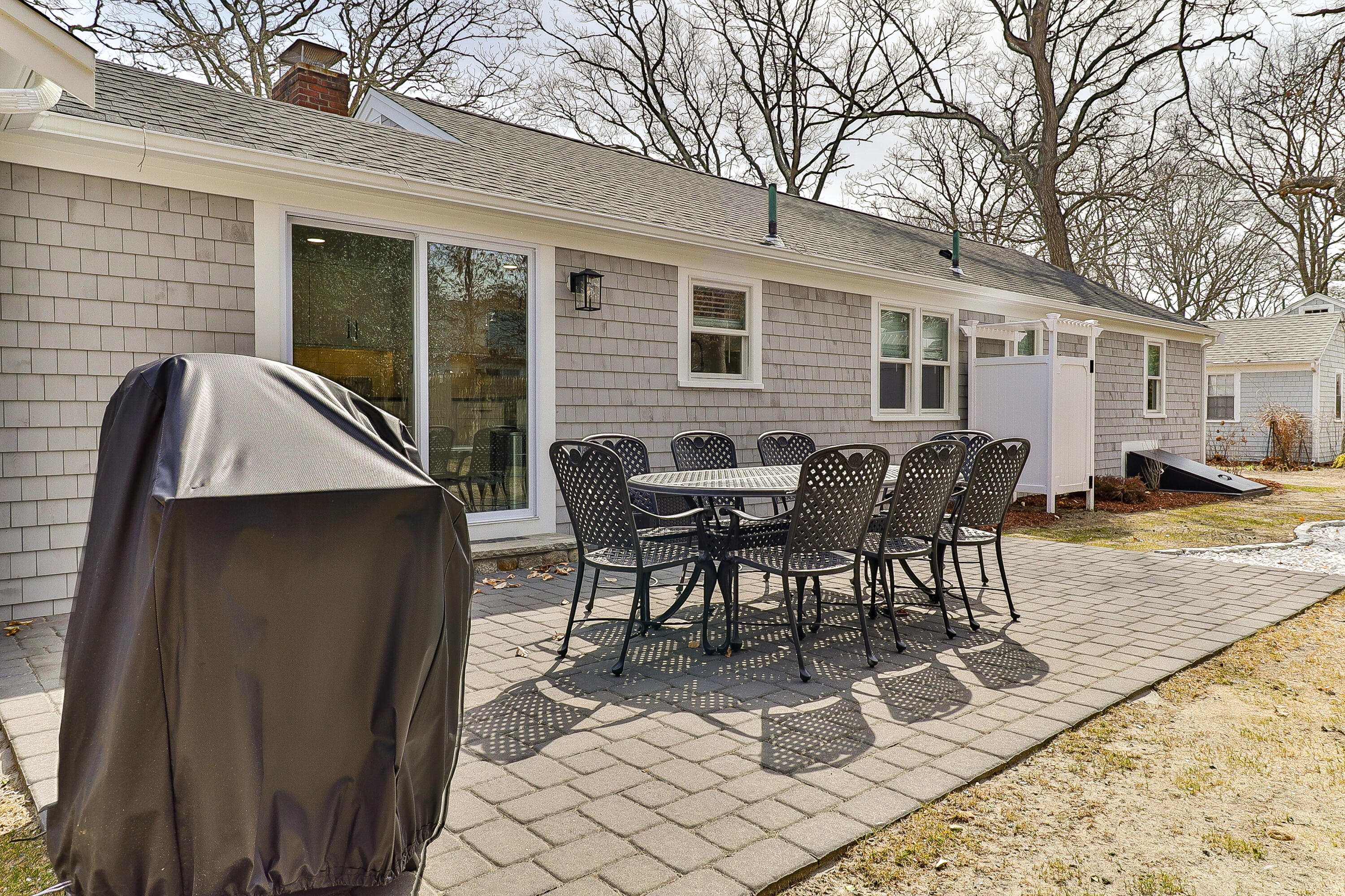 49 Huckins Neck Road Centerville, MA 02632 - Photo 23 of 23 a view of a dinning table and chairs in patio of the house