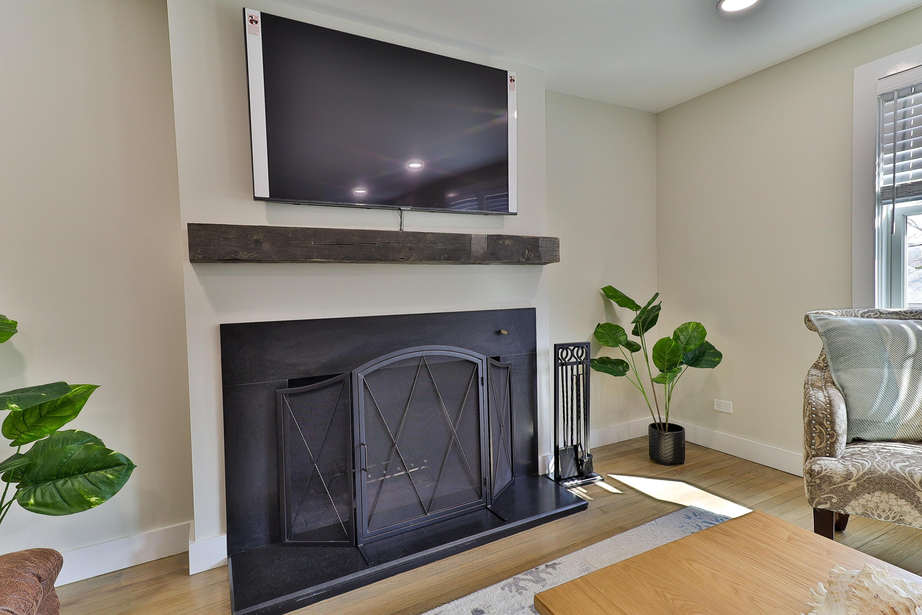 49 Huckins Neck Road Centerville, MA 02632 - Photo 4 of 23 a living room with a fireplace and potted plant