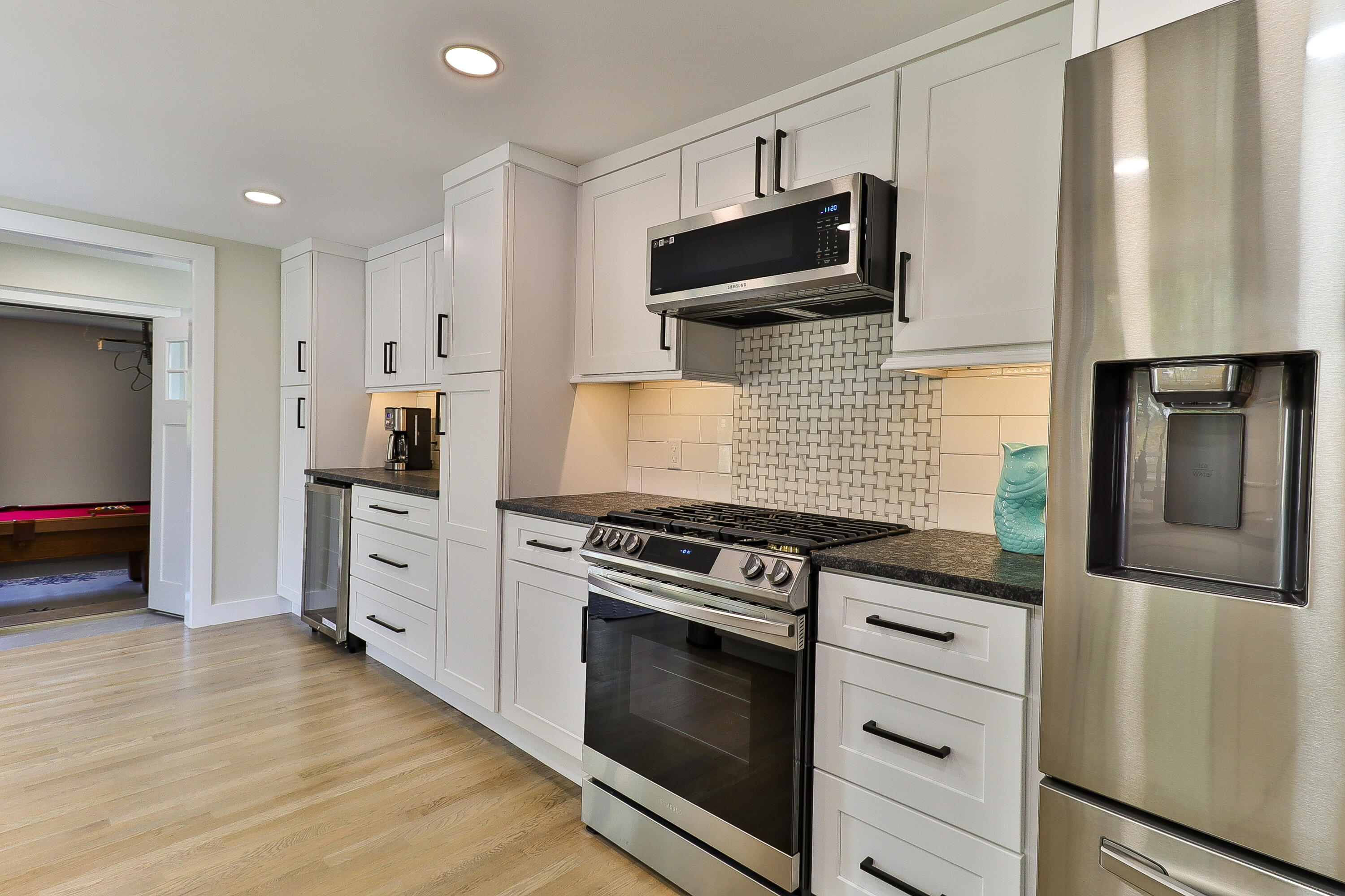 49 Huckins Neck Road Centerville, MA 02632 - Photo 6 of 23 a kitchen with stainless steel appliances kitchen island granite countertop a stove and a refrigerator