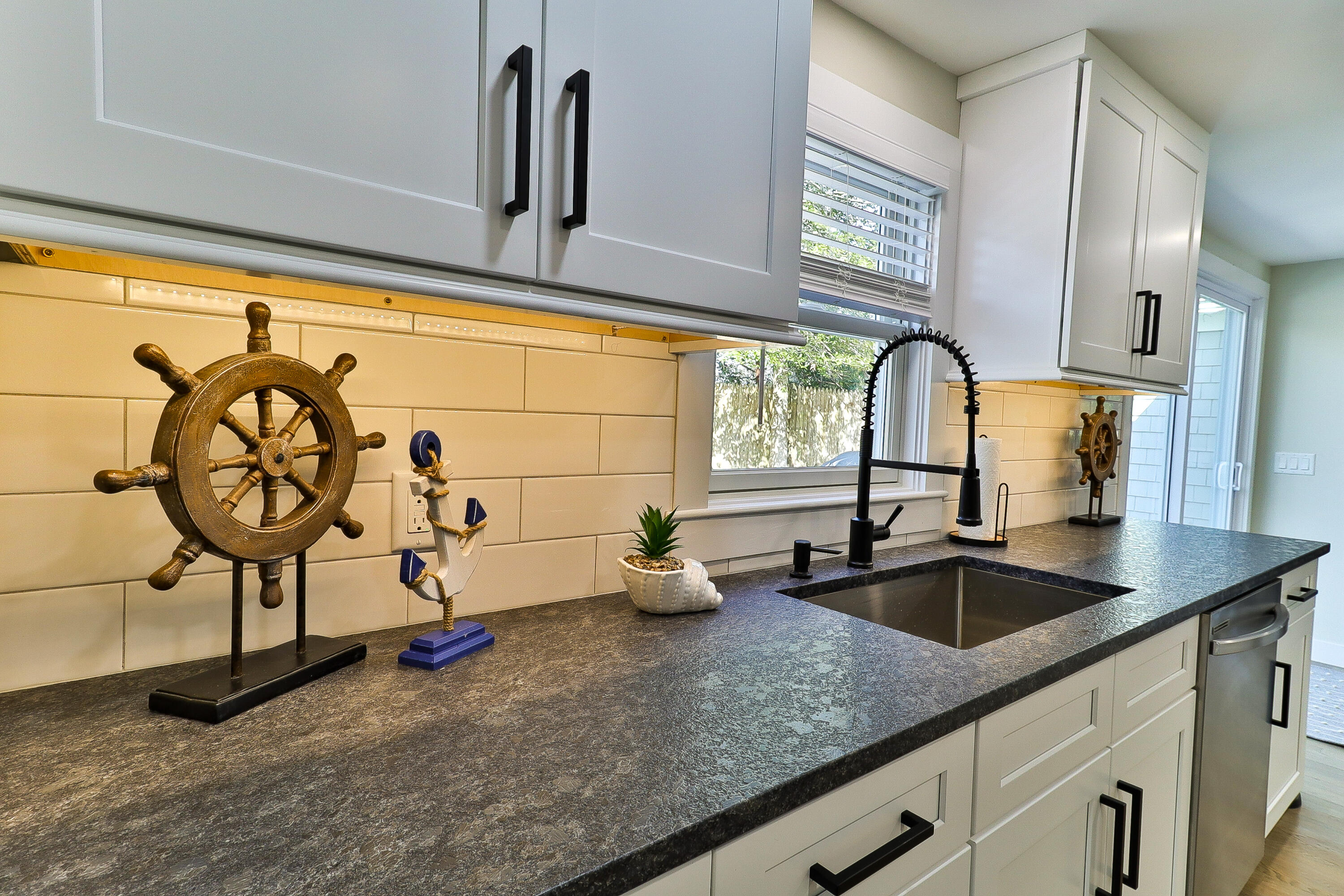 49 Huckins Neck Road Centerville, MA 02632 - Photo 7 of 23 a kitchen with sink a faucet and chandelier