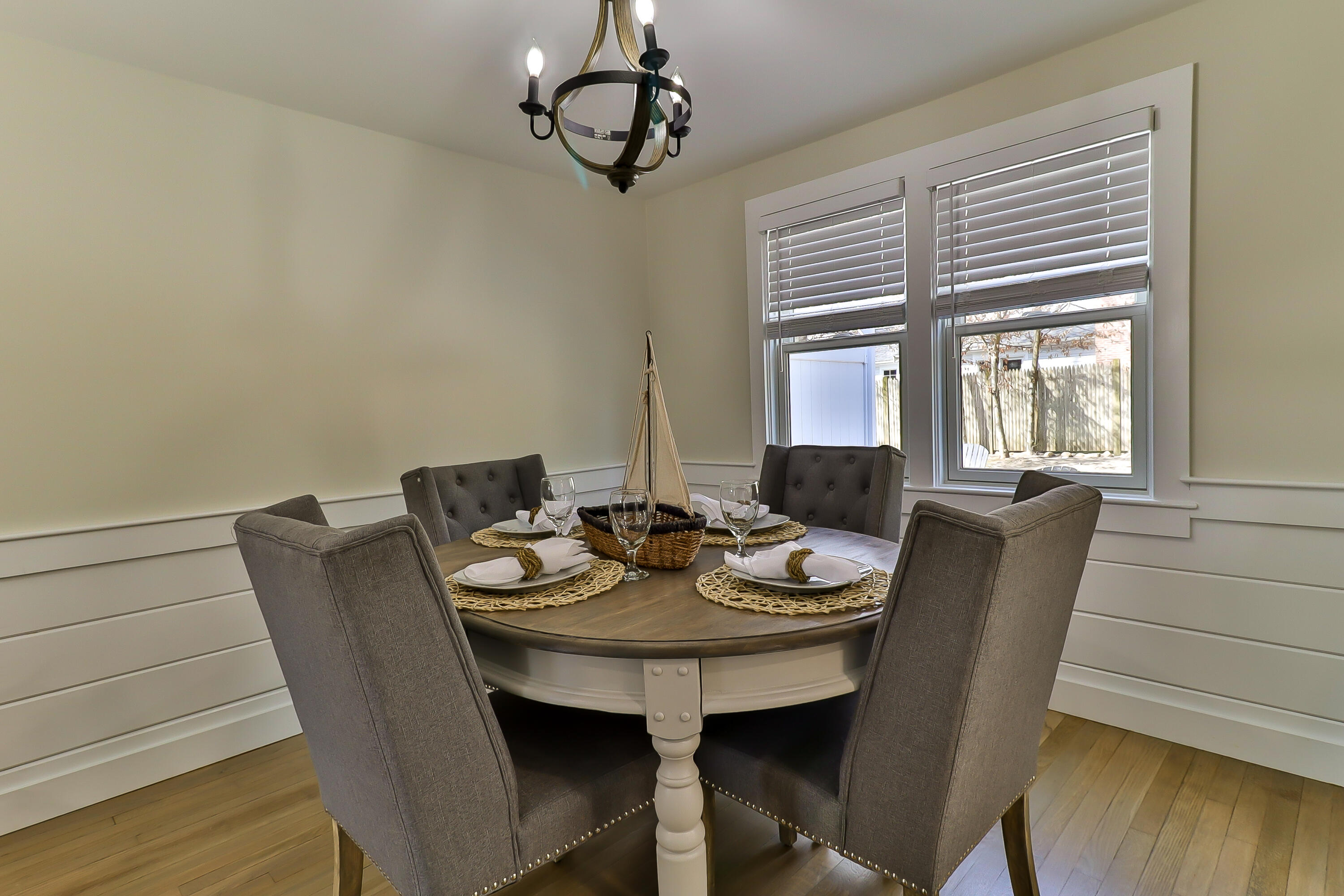 49 Huckins Neck Road Centerville, MA 02632 - Photo 10 of 23 a view of a dining room with furniture wooden floor and chandelier