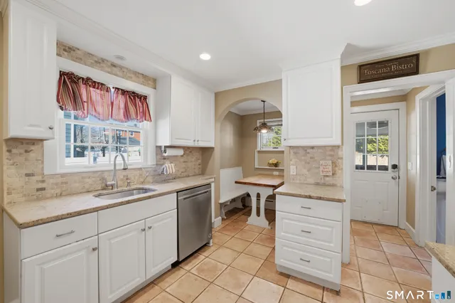 a spacious bathroom with a granite countertop sink mirror and a
