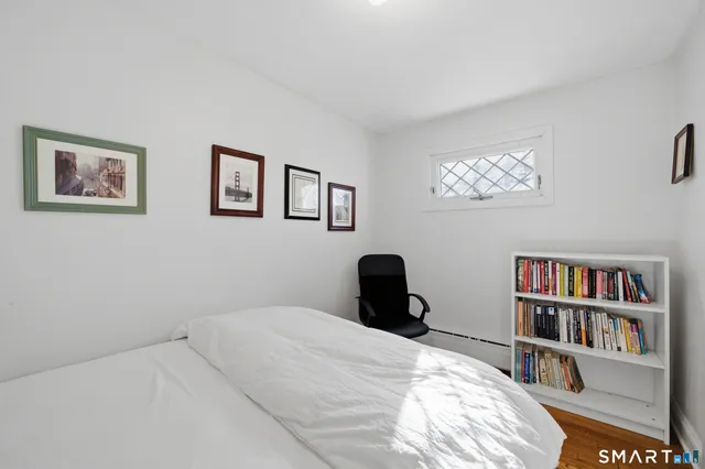 a bedroom with a bed and a book shelf