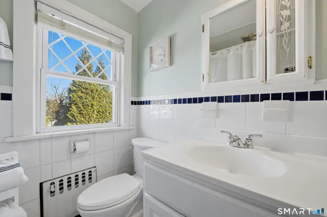 a bathroom with a sink a mirror and a shower