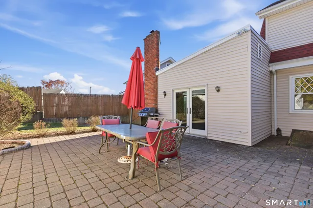 a view of a patio with a table and chairs