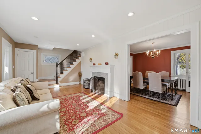 a living room with furniture fireplace and window