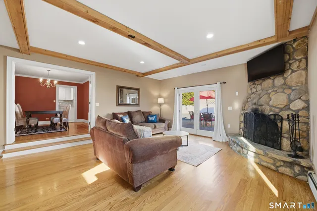 a living room with fireplace furniture and a flat screen tv
