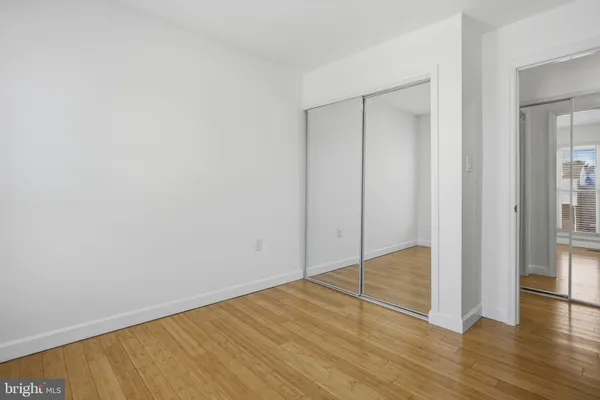 a view of wooden floor and windows in a room