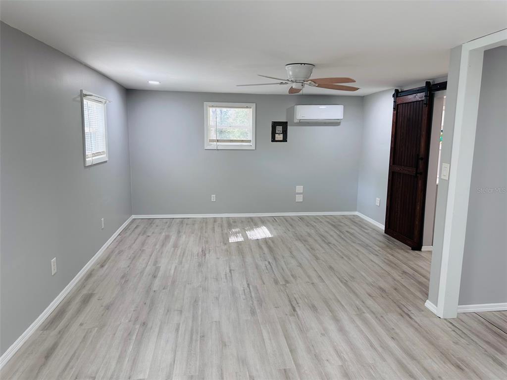 13750 Northwest 88th Terrace Chiefland, FL 32626 - Photo 11 of 33 wooden floor in an empty room with a window