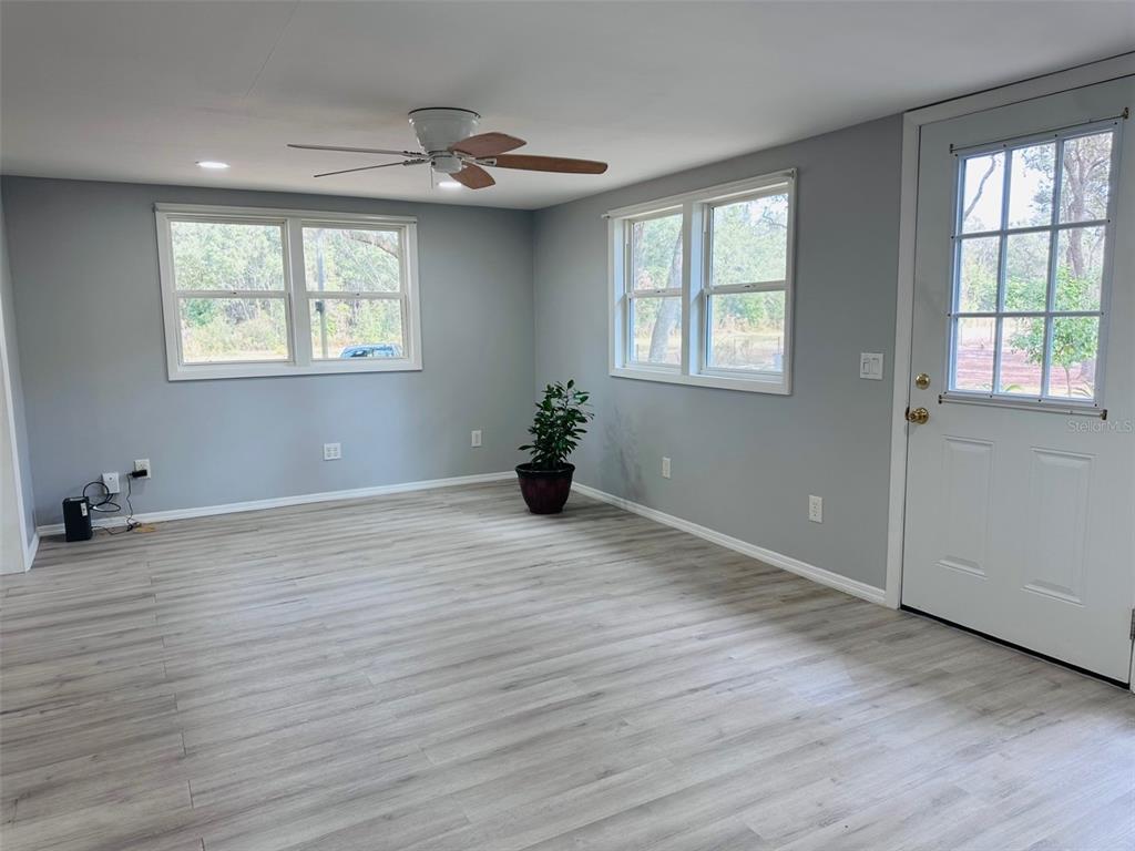 13750 Northwest 88th Terrace Chiefland, FL 32626 - Photo 2 of 33 a big room with wooden floor and windows