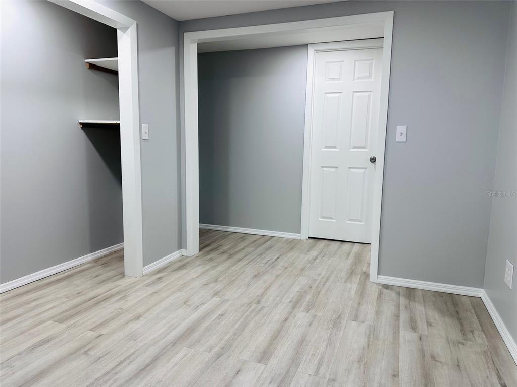 13750 Northwest 88th Terrace Chiefland, FL 32626 - Photo 21 of 33 a view of an empty room with wooden floor and closet