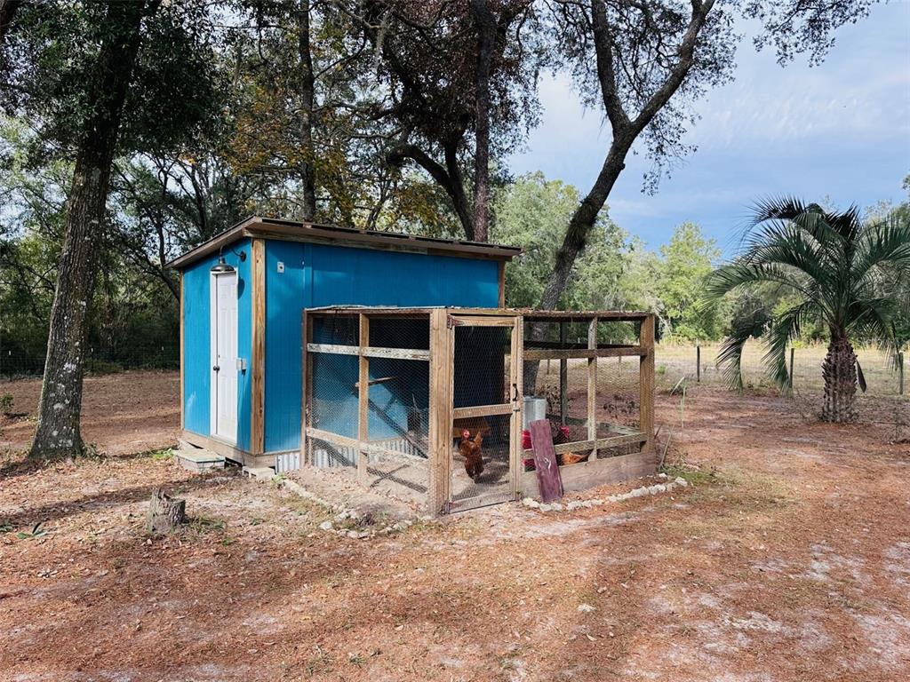 13750 Northwest 88th Terrace Chiefland, FL 32626 - Photo 30 of 33 a view of a house with backyard and trees