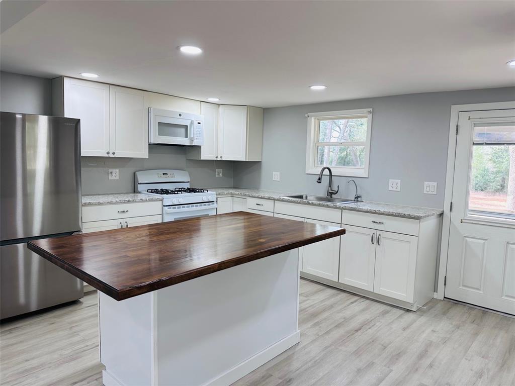 13750 Northwest 88th Terrace Chiefland, FL 32626 - Photo 3 of 33 a kitchen with kitchen island granite countertop a sink a counter space stainless steel appliances and cabinets