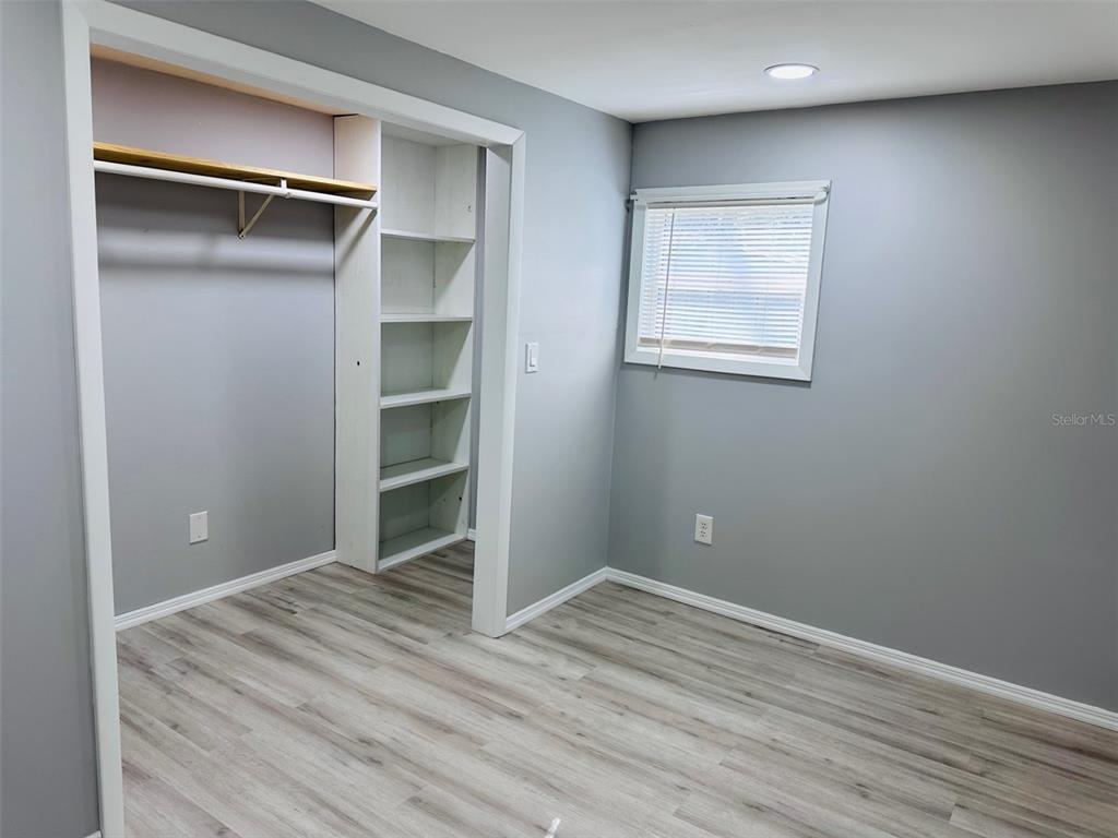 13750 Northwest 88th Terrace Chiefland, FL 32626 - Photo 4 of 33 a view of an empty room with wooden floor & cabinet