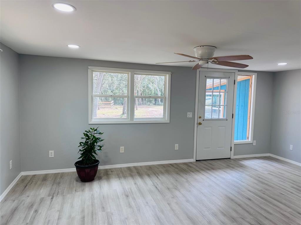 13750 Northwest 88th Terrace Chiefland, FL 32626 - Photo 6 of 33 a view of an empty room with wooden floor and a window