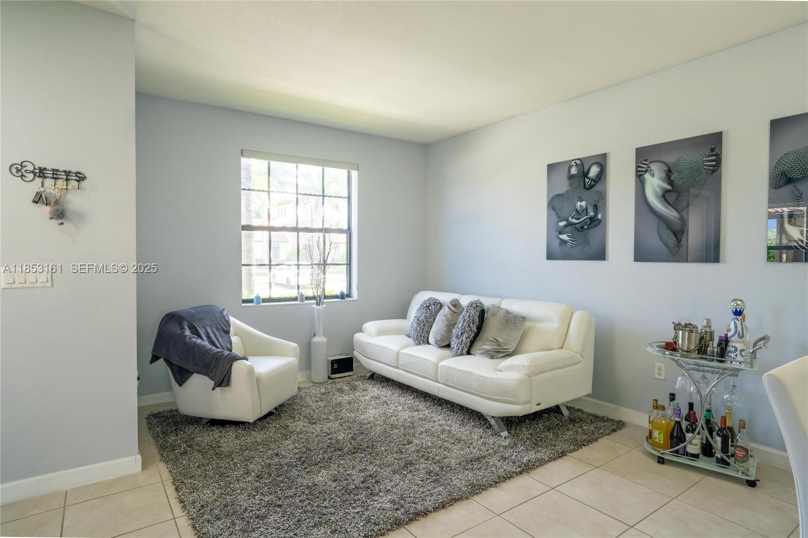 11571 Southwest 248th Lane Homestead, FL 33032 - Photo 11 of 26 a living room with furniture and a window