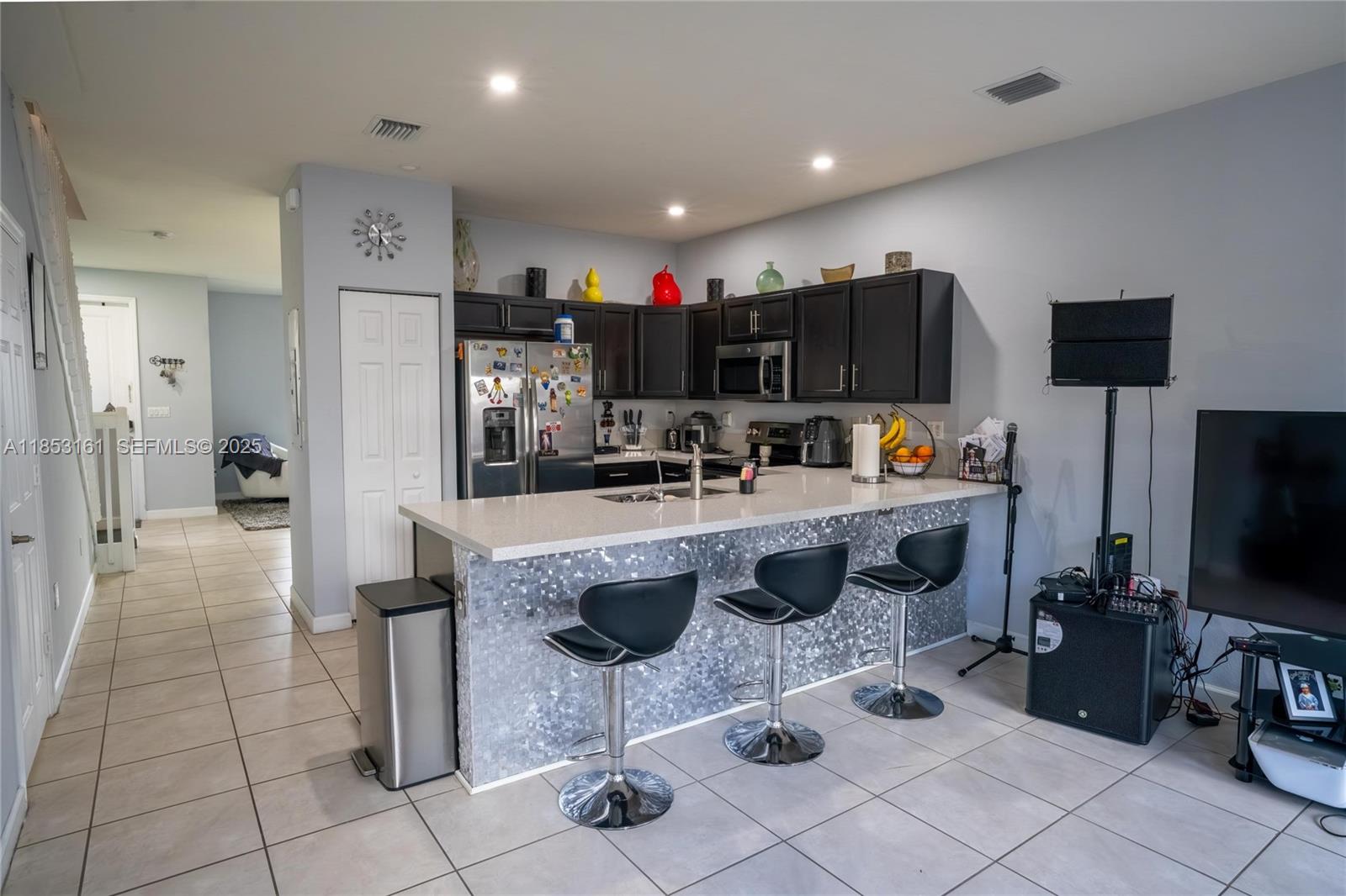 11571 Southwest 248th Lane Homestead, FL 33032 - Photo 15 of 26 a kitchen with stainless steel appliances granite countertop a sink and a refrigerator