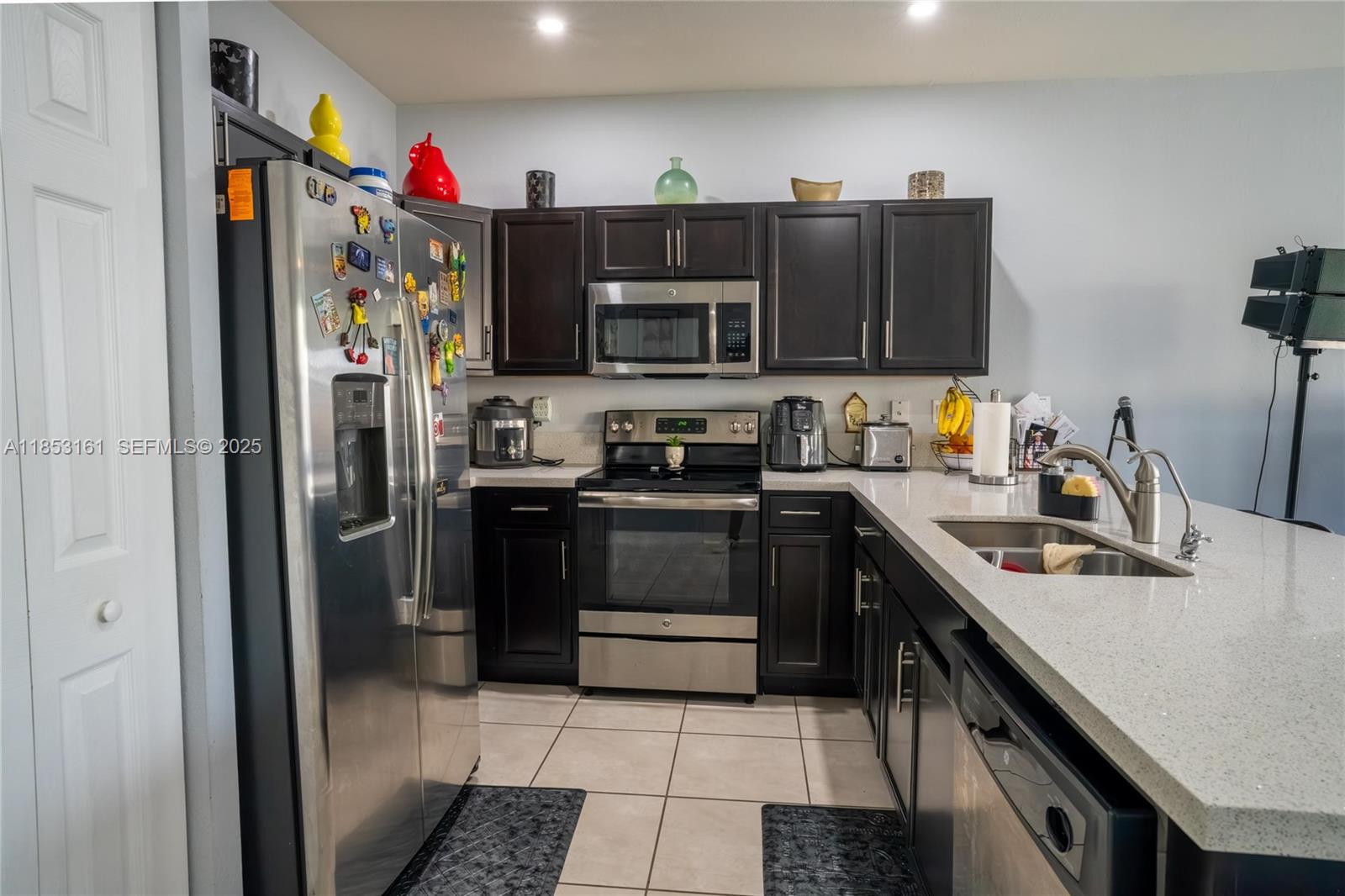 11571 Southwest 248th Lane Homestead, FL 33032 - Photo 16 of 26 a kitchen with stainless steel appliances granite countertop a refrigerator stove and sink