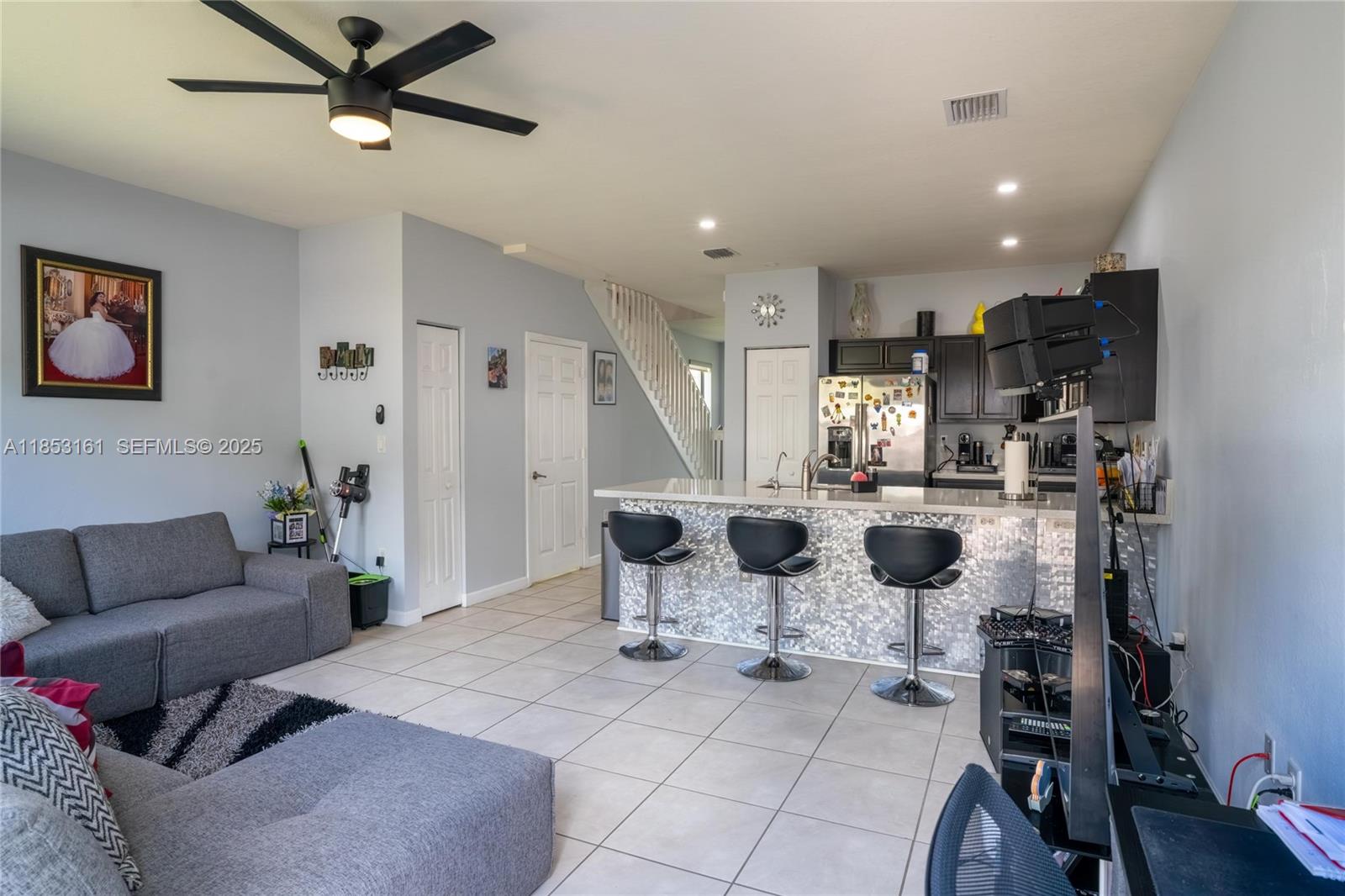 11571 Southwest 248th Lane Homestead, FL 33032 - Photo 17 of 26 a living room with furniture a large window and flat screen tv