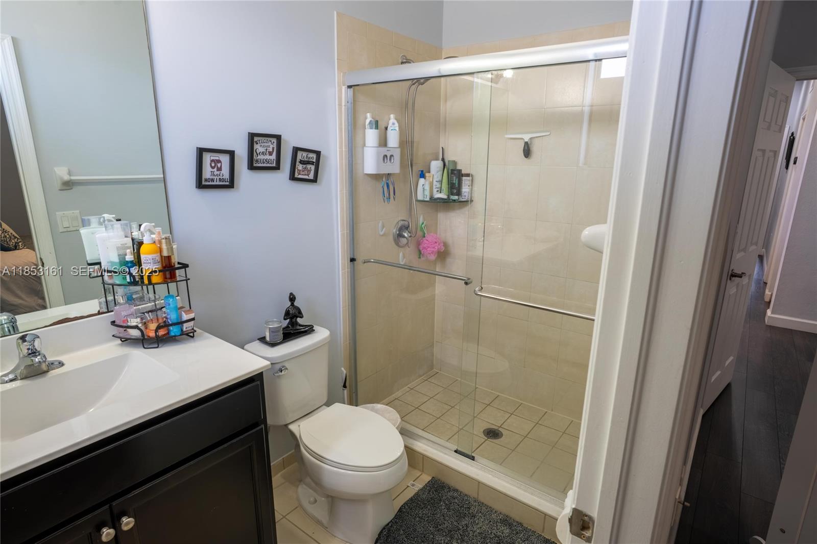 11571 Southwest 248th Lane Homestead, FL 33032 - Photo 21 of 26 a bathroom with a sink a toilet and shower