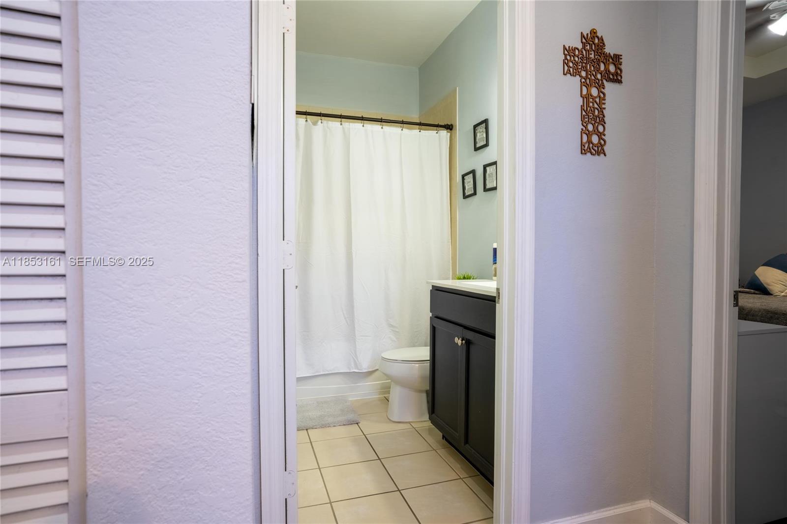 11571 Southwest 248th Lane Homestead, FL 33032 - Photo 23 of 26 a bathroom with a sink and a mirror