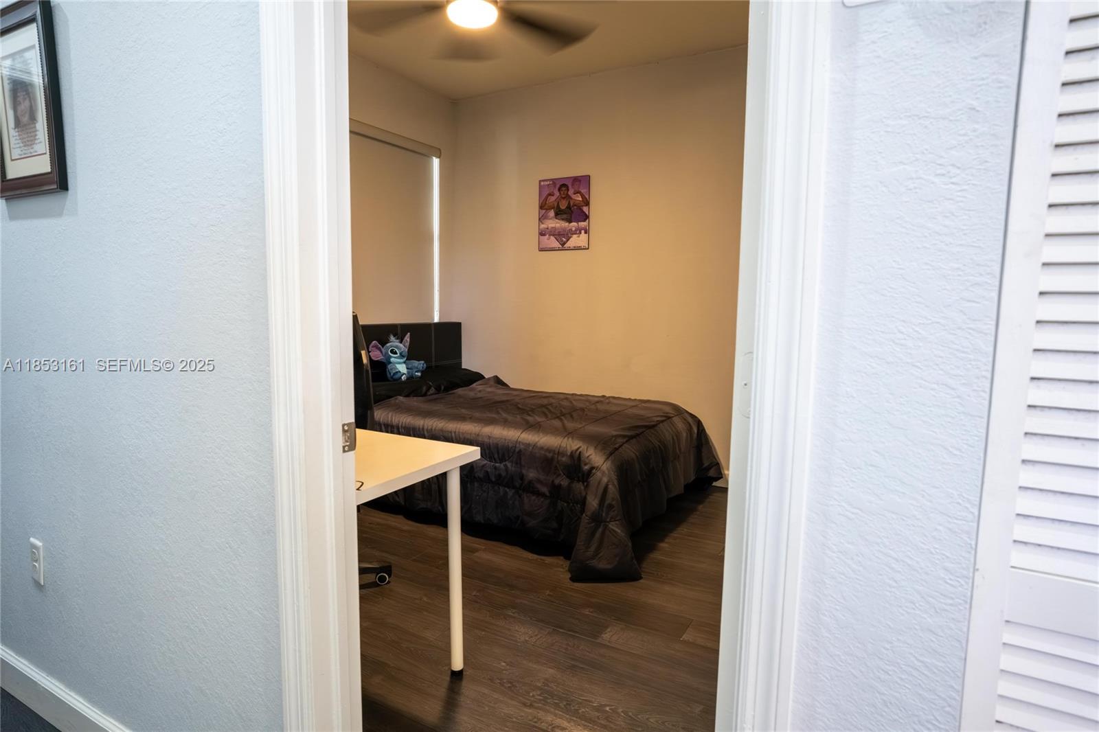 11571 Southwest 248th Lane Homestead, FL 33032 - Photo 24 of 26 a bedroom with a bed and wooden floor