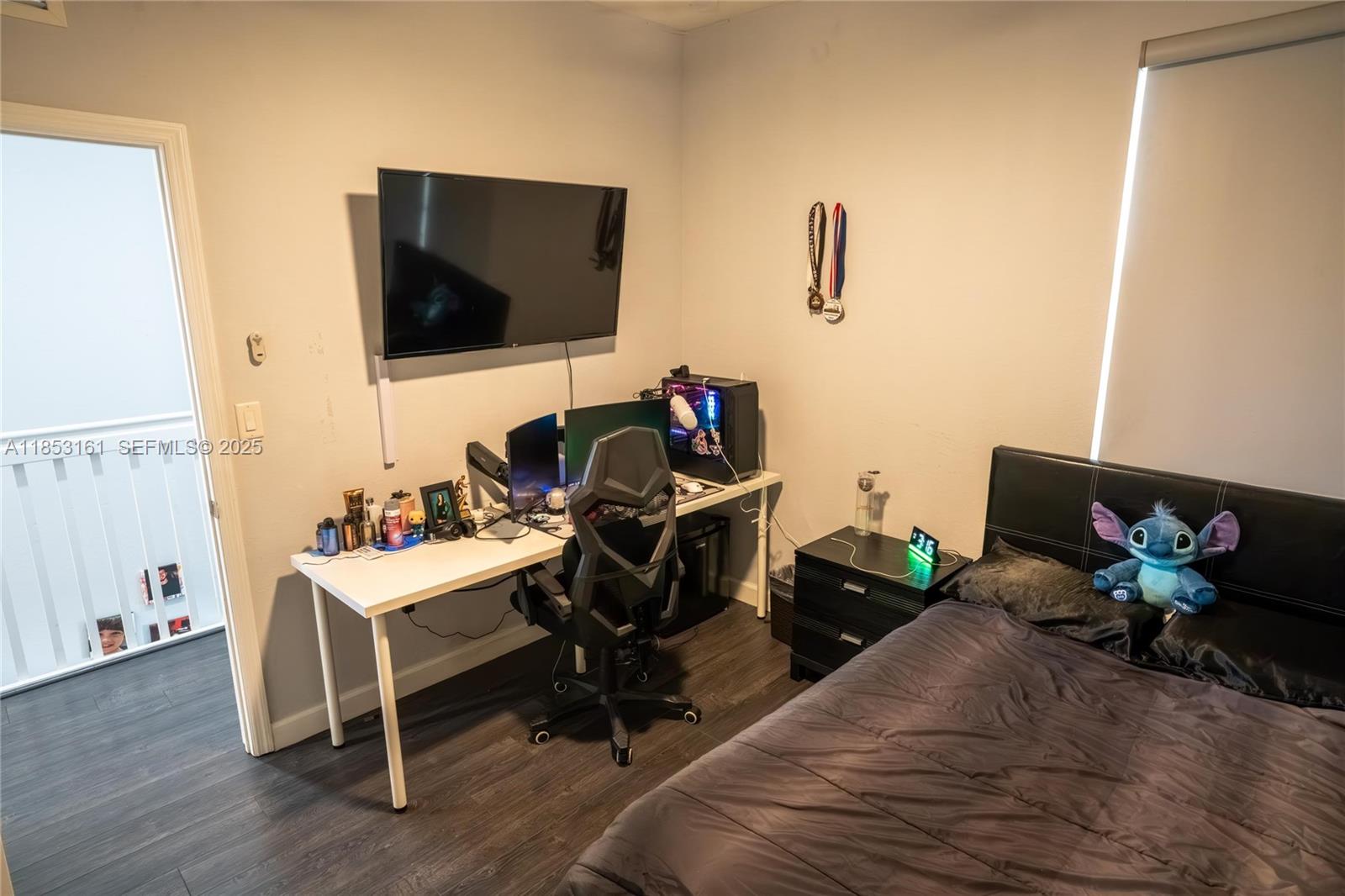 11571 Southwest 248th Lane Homestead, FL 33032 - Photo 25 of 26 a living room with furniture wooden floor and a flat screen tv