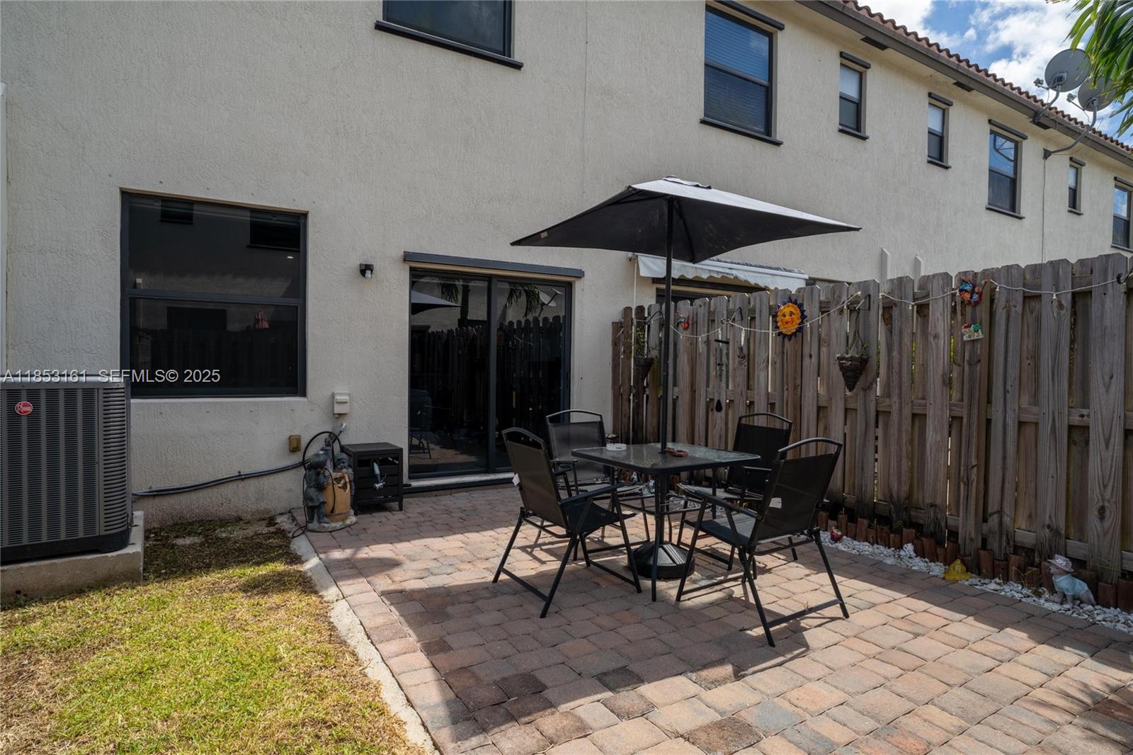 11571 Southwest 248th Lane Homestead, FL 33032 - Photo 7 of 26 a patio with a table and chairs