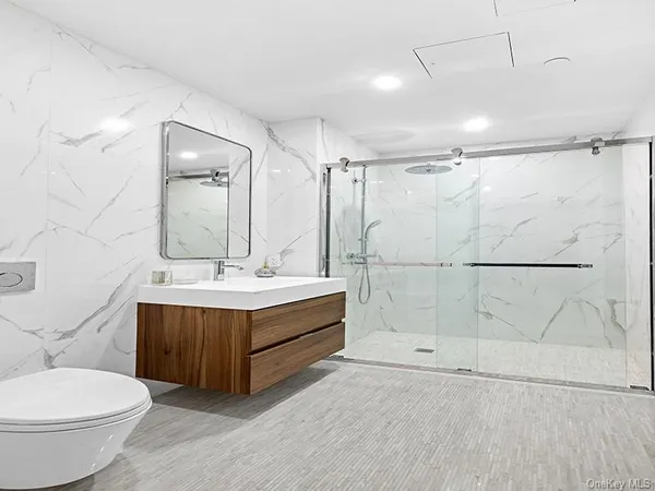 a bathroom with a sink mirror vanity and toilet