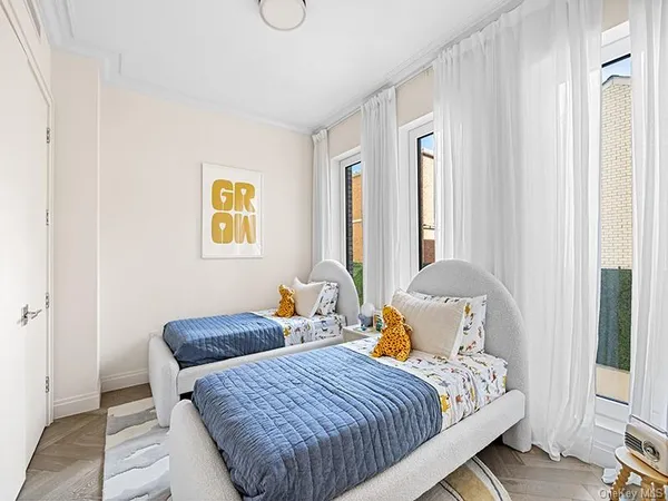 a bedroom with two beds and a window