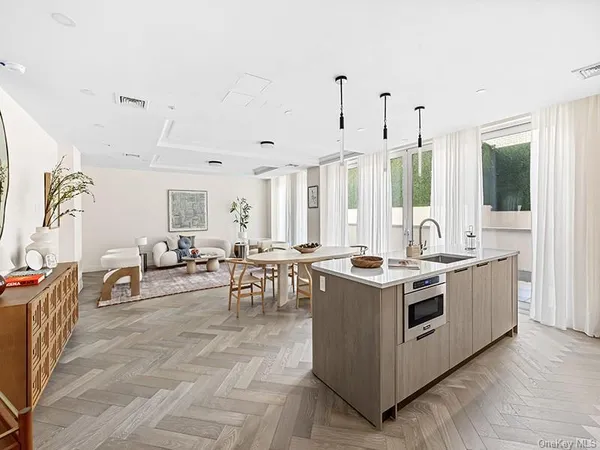 a kitchen with stainless steel appliances granite countertop a stove and a view of living room