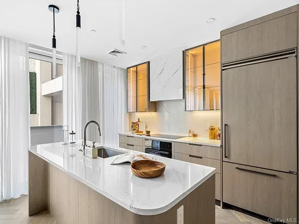 a kitchen with stainless steel appliances a sink and a refrigerator