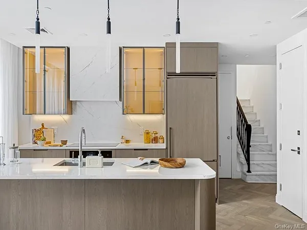 a bathroom with a sink a refrigerator and a mirror